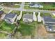 Aerial view of the backyard featuring a deck and screened porch, surrounded by green grass and neighboring houses at 5158 Mill Creek Rd, Clover, SC 29710