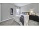 Serene bedroom featuring a cozy bed, stylish wall art, and soft natural light from the window at 5158 Mill Creek Rd, Clover, SC 29710