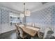 Stylish dining room showcasing a wooden table set for dinner, modern light fixtures, and abundant natural light at 5158 Mill Creek Rd, Clover, SC 29710