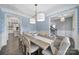 Elegant dining room with patterned wallpaper, modern lighting, a wooden table, and seating for six at 5158 Mill Creek Rd, Clover, SC 29710