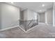 Spacious hallway with a neutral palette, elegant staircase, and plush carpeting at 5158 Mill Creek Rd, Clover, SC 29710