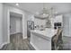 Beautiful white kitchen with stainless appliances, large island and pendant lights at 5158 Mill Creek Rd, Clover, SC 29710