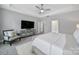 Comfortable main bedroom with an entertainment center, a ceiling fan, and natural lighting at 5158 Mill Creek Rd, Clover, SC 29710