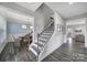 Open staircase leading to the second floor, complemented by adjacent dining and living spaces at 5158 Mill Creek Rd, Clover, SC 29710