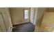 Bedroom with neutral walls, window, and door at 525 S Trenton St, Gastonia, NC 28052