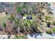 Aerial view of home surrounded by a wooded lot outlined in red with road access at 5369 Concord Rd, York, SC 29745