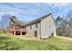 Backyard view featuring a covered deck, partial garage, and green surroundings at 5369 Concord Rd, York, SC 29745