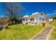 Traditional white home with a welcoming front porch, lush lawn, and mature landscaping at 60 Central Ave, Gastonia, NC 28054