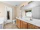 Bathroom featuring a double vanity, tile floors, and a large mirror at 6311 Gold Dust Ct, Charlotte, NC 28269