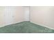 The carpeted bedroom has neutral walls and a double door closet at 6311 Gold Dust Ct, Charlotte, NC 28269