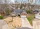 Aerial view of brick home featuring a landscaped yard and driveway leading to an attached two-car garage at 6311 Gold Dust Ct, Charlotte, NC 28269