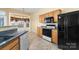 A kitchen featuring a breakfast nook with a bay window, stainless steel appliances and wood cabinetry at 6311 Gold Dust Ct, Charlotte, NC 28269