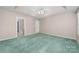 Bright main bedroom with tray ceilings, carpet, and an ensuite bathroom at 6311 Gold Dust Ct, Charlotte, NC 28269