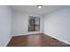 Bedroom featuring a bright light fixture and a window overlooking trees at 6415 Santa Cruz Trl # 11, Charlotte, NC 28227