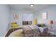 Bright bedroom featuring a sunny rug, a charming bed, and vibrant decor at 6415 Santa Cruz Trl # 11, Charlotte, NC 28227