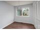 Bedroom with wood floors, window, a modern light fixture, and closet at 6415 Santa Cruz Trl # 11, Charlotte, NC 28227