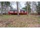 Backyard view of home featuring a deck, neutral paint, and brick chimney at 6415 Santa Cruz Trl # 11, Charlotte, NC 28227