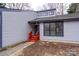 Inviting home entrance with bright red stairs and landscaping at 6415 Santa Cruz Trl # 11, Charlotte, NC 28227