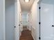 Hallway featuring neutral-toned walls and updated doors with black hardware at 6415 Santa Cruz Trl # 11, Charlotte, NC 28227