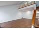 Spacious living room with wood floors and open staircase at 6415 Santa Cruz Trl # 11, Charlotte, NC 28227