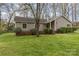 Well-maintained single-story home with lush green lawn and mature landscaping at 7305 Park Vista Cir, Charlotte, NC 28226