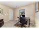 This home office features carpet floors, neutral walls, and a window that provides natural light at 7305 Park Vista Cir, Charlotte, NC 28226