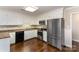 Modern kitchen with stainless steel appliances, hardwood floors, and white cabinets at 7305 Park Vista Cir, Charlotte, NC 28226