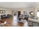 Spacious living room featuring hardwood floors and multiple sofas with sliding glass doors to the deck at 7305 Park Vista Cir, Charlotte, NC 28226