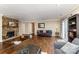 Spacious living room featuring hardwood floors, recessed seating area, and stone fireplace at 7305 Park Vista Cir, Charlotte, NC 28226