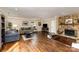 Bright living room with dark hardwood flooring, a ceiling fan, and a stone fireplace at 7305 Park Vista Cir, Charlotte, NC 28226