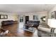 Spacious living room featuring hardwood floors and multiple sofas with sliding glass doors to the deck at 7305 Park Vista Cir, Charlotte, NC 28226