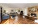 Cozy living room featuring hardwood floors, stone fireplace, and plush sofas at 7305 Park Vista Cir, Charlotte, NC 28226