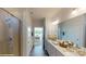 Bright bathroom featuring double vanity, quartz countertop, large mirror, walk-in shower, and wood-style floors at 7669 Bainbridge Rd, Sherrills Ford, NC 28673