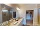 Bright bathroom featuring double vanity, quartz countertop, large mirror, and walk-in closet and glass shower at 7669 Bainbridge Rd, Sherrills Ford, NC 28673