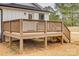 Elevated wooden back deck with stairs, view of the house, and spacious yard for outdoor enjoyment at 818 E Charles St, Matthews, NC 28105