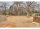 Large backyard with room for activities, access to wooden back deck, and lots of tree coverage at 818 E Charles St, Matthews, NC 28105