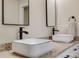 Close-up on modern bathroom with granite countertops and white square sinks with black trim and fixtures at 818 E Charles St, Matthews, NC 28105