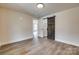 Spacious bedroom featuring wood-look floors and a rustic sliding barn door closet at 818 E Charles St, Matthews, NC 28105