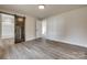 Bright bedroom with a sliding barn door entrance to bathroom, and hardwood flooring at 818 E Charles St, Matthews, NC 28105