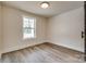 Neutral bedroom with wood-look floors, a window, and ample space for furniture at 818 E Charles St, Matthews, NC 28105