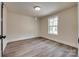 Bright bedroom with wood-look floors and a large window, providing natural light at 818 E Charles St, Matthews, NC 28105