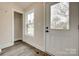 Bright entryway with window, coat closet, and front door leading to the exterior of the home at 818 E Charles St, Matthews, NC 28105