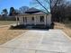 Charming white home with a inviting front porch, newly laid driveway and manicured lawn at 818 E Charles St, Matthews, NC 28105