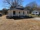 Beautifully renovated white home featuring a classic front porch with updated landscaping at 818 E Charles St, Matthews, NC 28105