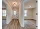 Bright hallway with wood-look floors, leading to various rooms in the home at 818 E Charles St, Matthews, NC 28105