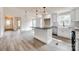 Bright, open kitchen featuring white cabinetry, a center island, and stainless steel appliances at 818 E Charles St, Matthews, NC 28105