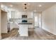 Modern kitchen with white cabinets, stainless steel appliances, and functional island with black countertop at 818 E Charles St, Matthews, NC 28105