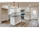 A modern kitchen featuring white cabinets, stainless steel appliances, and an island at 818 E Charles St, Matthews, NC 28105