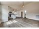 Open-concept living area featuring modern flooring and a view into the bright kitchen and dining spaces at 818 E Charles St, Matthews, NC 28105