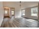 Bright living room with light-filled windows and stylish flooring, with views to the entry at 818 E Charles St, Matthews, NC 28105